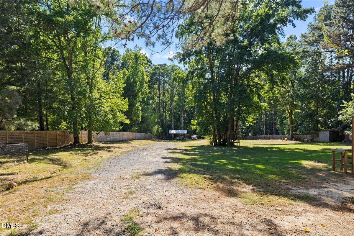 1304 Flying Hawk Road Apex, NC 27523 - Photo 42 of 52 a swimming pool with trees in the background