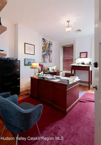 a living room with furniture and a piano