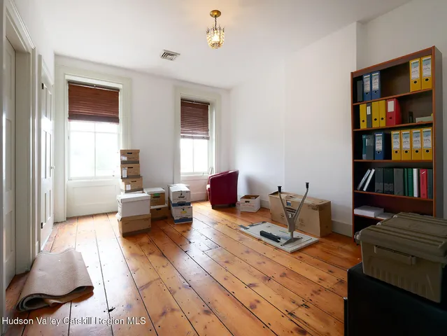 a living room with furniture and a book shelf