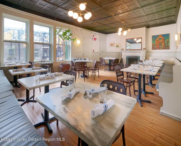 a outdoor dining space with furniture and wooden floor
