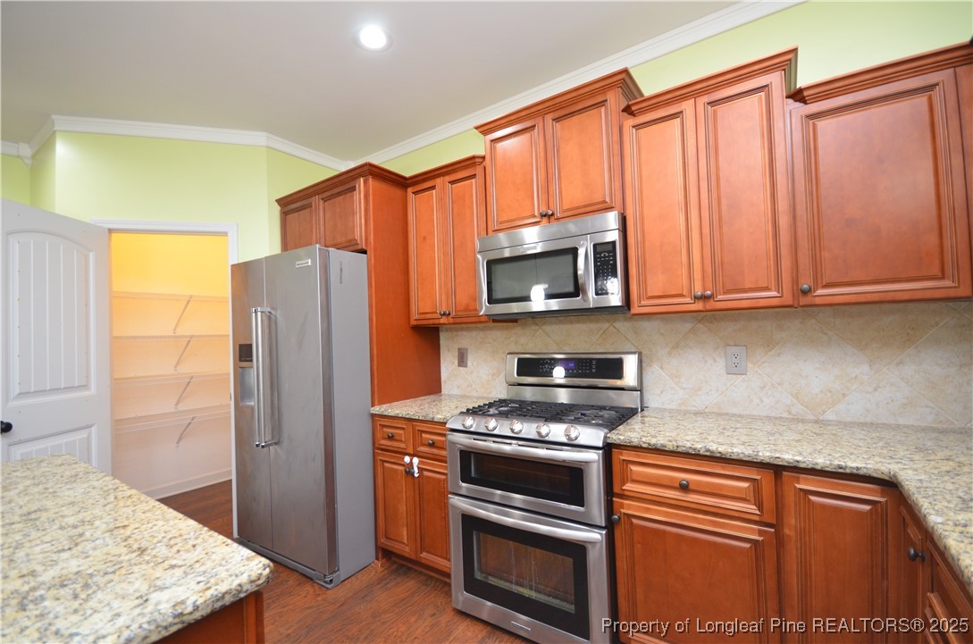281 Ganton Drive Raeford, NC 28376 - Photo 17 of 50 a kitchen with stainless steel appliances granite countertop a refrigerator stove and microwave