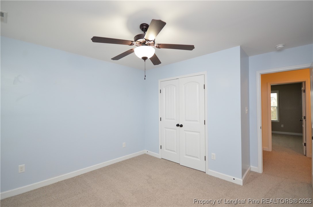 281 Ganton Drive Raeford, NC 28376 - Photo 35 of 50 an empty room with closet and a chandelier fan