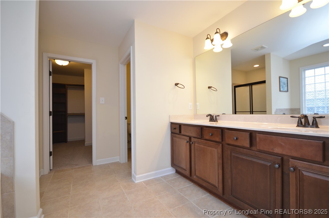 281 Ganton Drive Raeford, NC 28376 - Photo 43 of 50 a bathroom with a double vanity sink and a mirror
