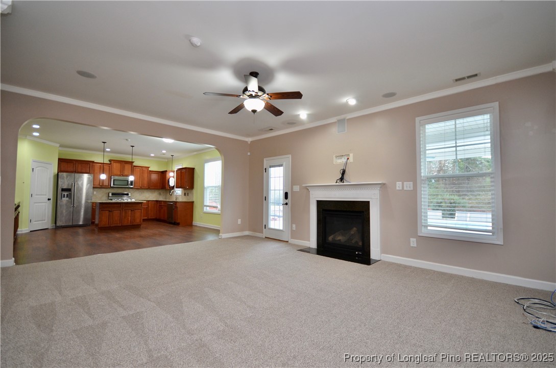 281 Ganton Drive Raeford, NC 28376 - Photo 9 of 50 a view of an empty room with a fireplace and a window