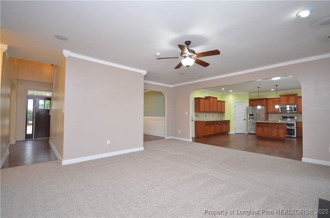 281 Ganton Drive Raeford, NC 28376 - Photo 10 of 50 a view of a livingroom with a flat screen tv wooden floor and a ceiling fan