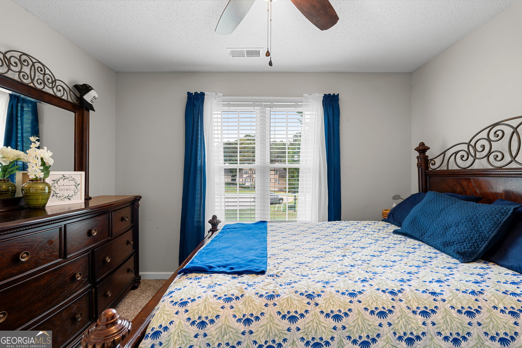 375 Gaelic Way Tyrone, GA 30290 - Photo 22 of 54 a bedroom with a large bed and a dresser