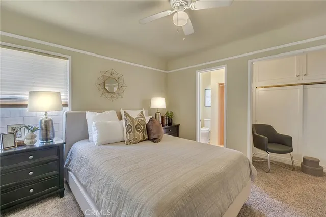 a bedroom with a bed and a chair