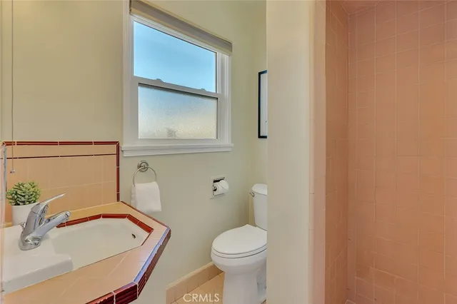 a bathroom with a sink toilet and mirror