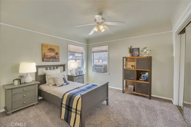 a spacious bedroom with a bed and a chandelier