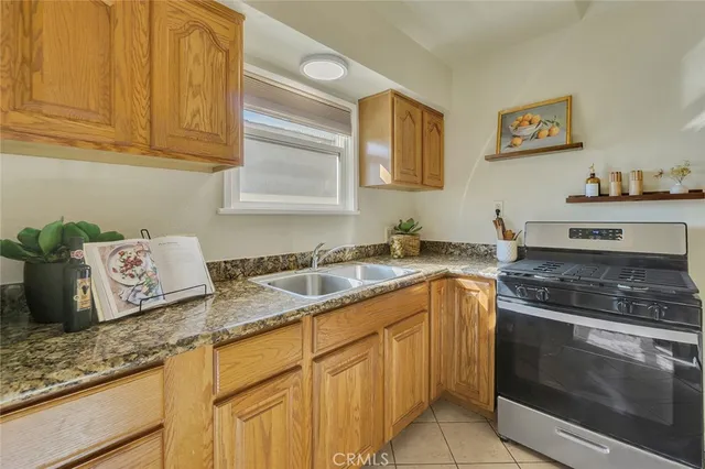 a kitchen with stainless steel appliances granite countertop a sink stove and cabinets