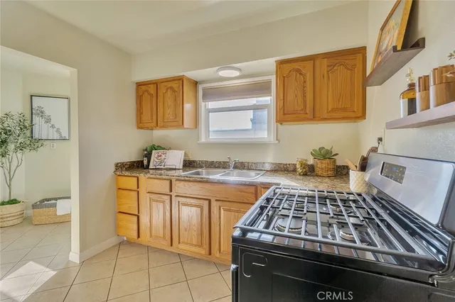 a kitchen with granite countertop a stove and a sink