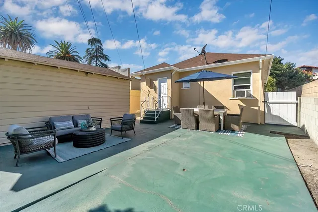 a view of a patio with couple of chairs