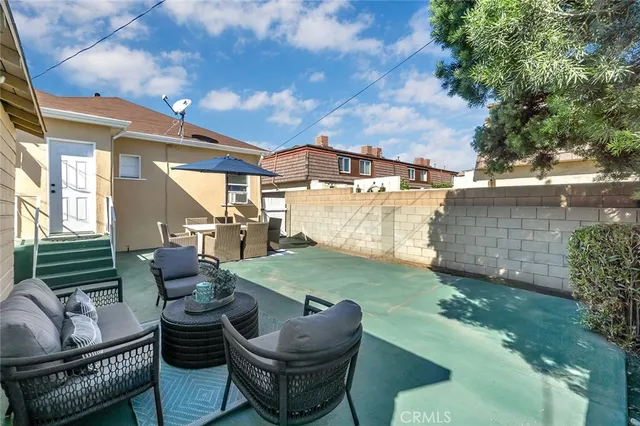 a view of backyard of house with seating space
