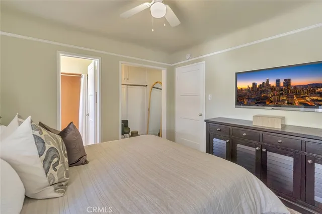 a bedroom with a large bed and a flat screen tv