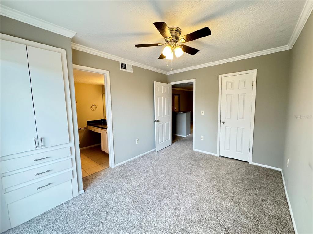 120 Blue Pointe Way, Unit 320 Altamonte Springs, FL 32701 - Photo 16 of 27 an empty room with closet and a chandelier fan