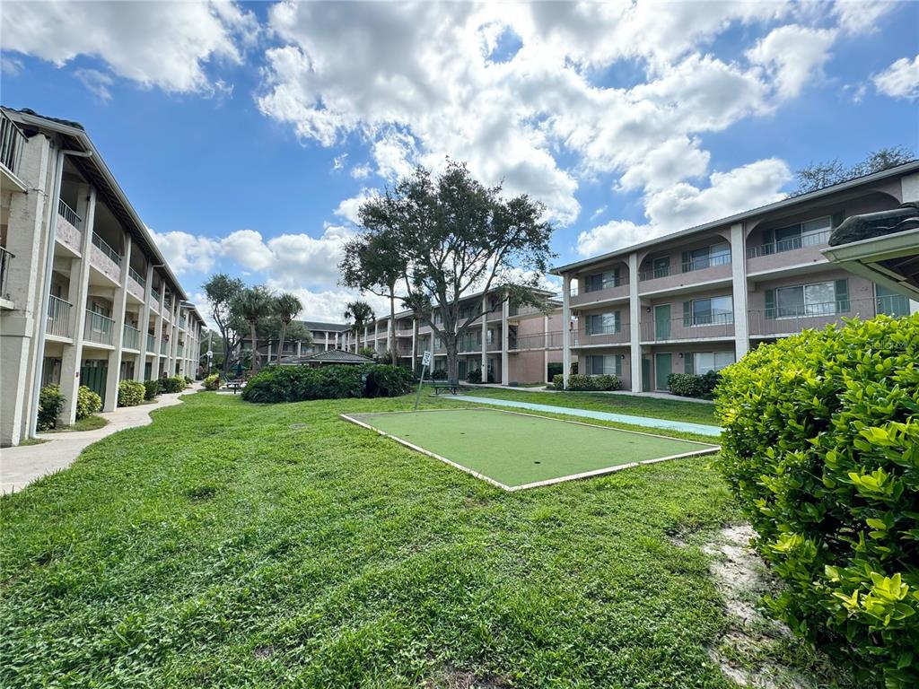 120 Blue Pointe Way, Unit 320 Altamonte Springs, FL 32701 - Photo 19 of 27 a view of a building with a big yard and large trees