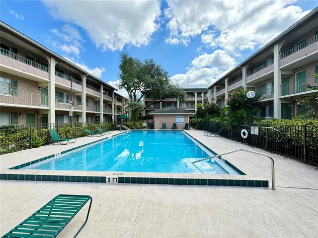 a view of a house with pool and sitting area