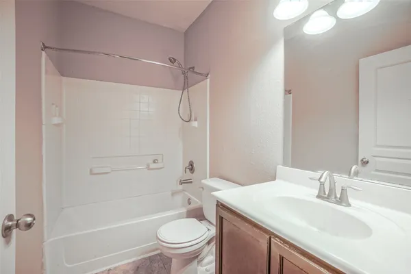 a bathroom with a sink toilet vanity and shower