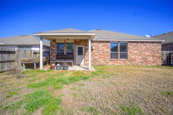 a view of a house with backyard porch and sitting area