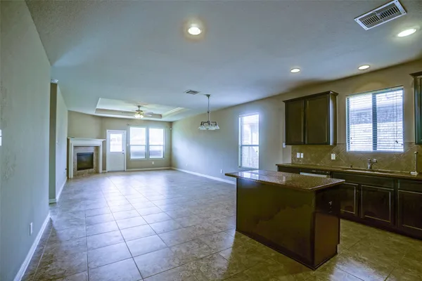 a view of a kitchen center island and living room