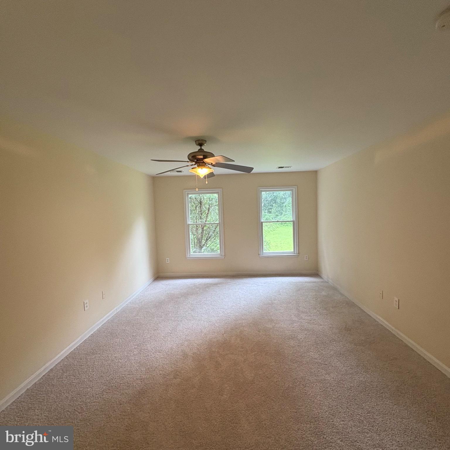 3502 Holly Road Annandale, VA 22003 - Photo 32 of 57 an empty room with windows and chandelier fan