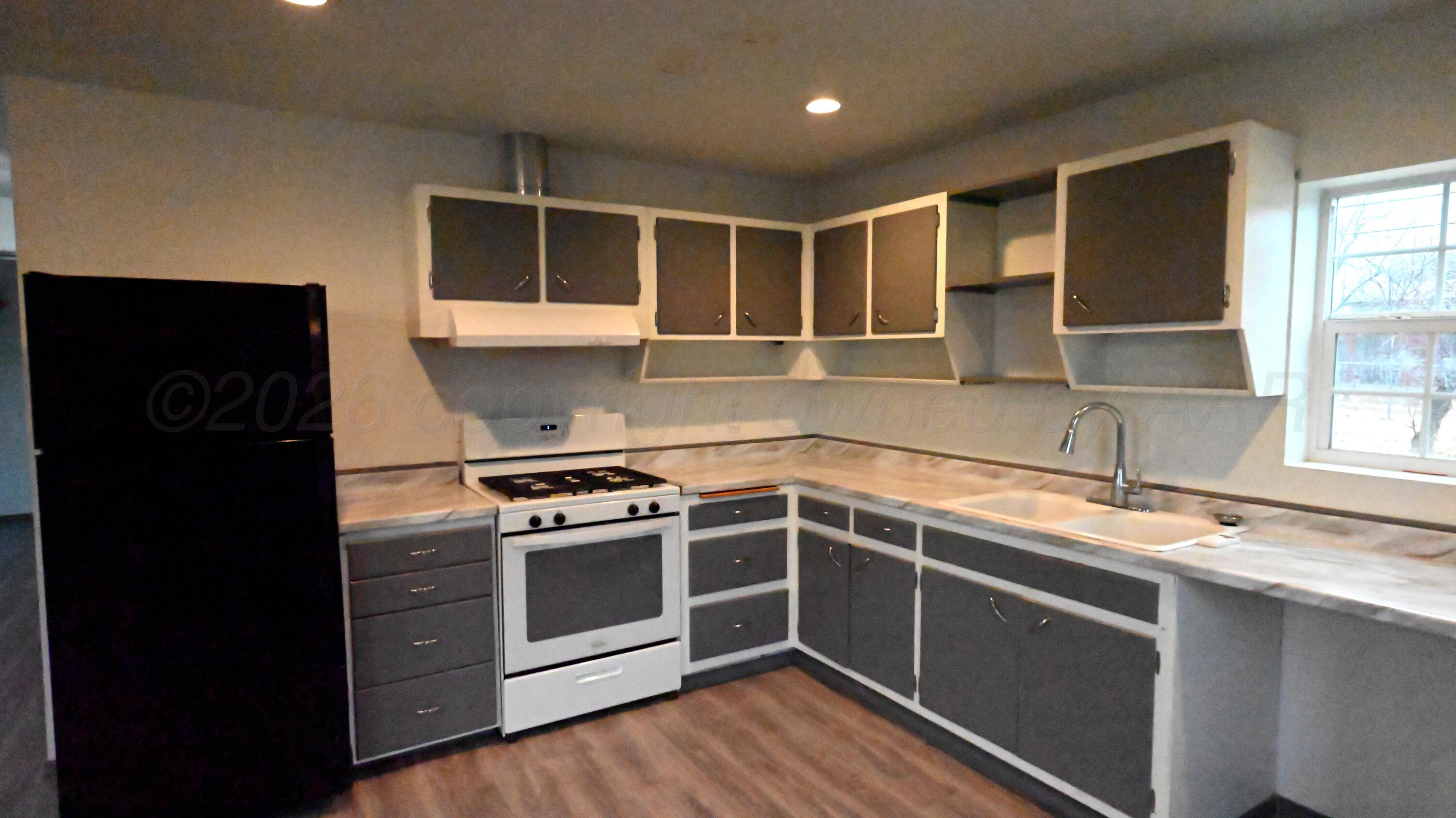 306 Union Street Borger, TX 79007 - Photo 4 of 12 a kitchen with a stove and a sink