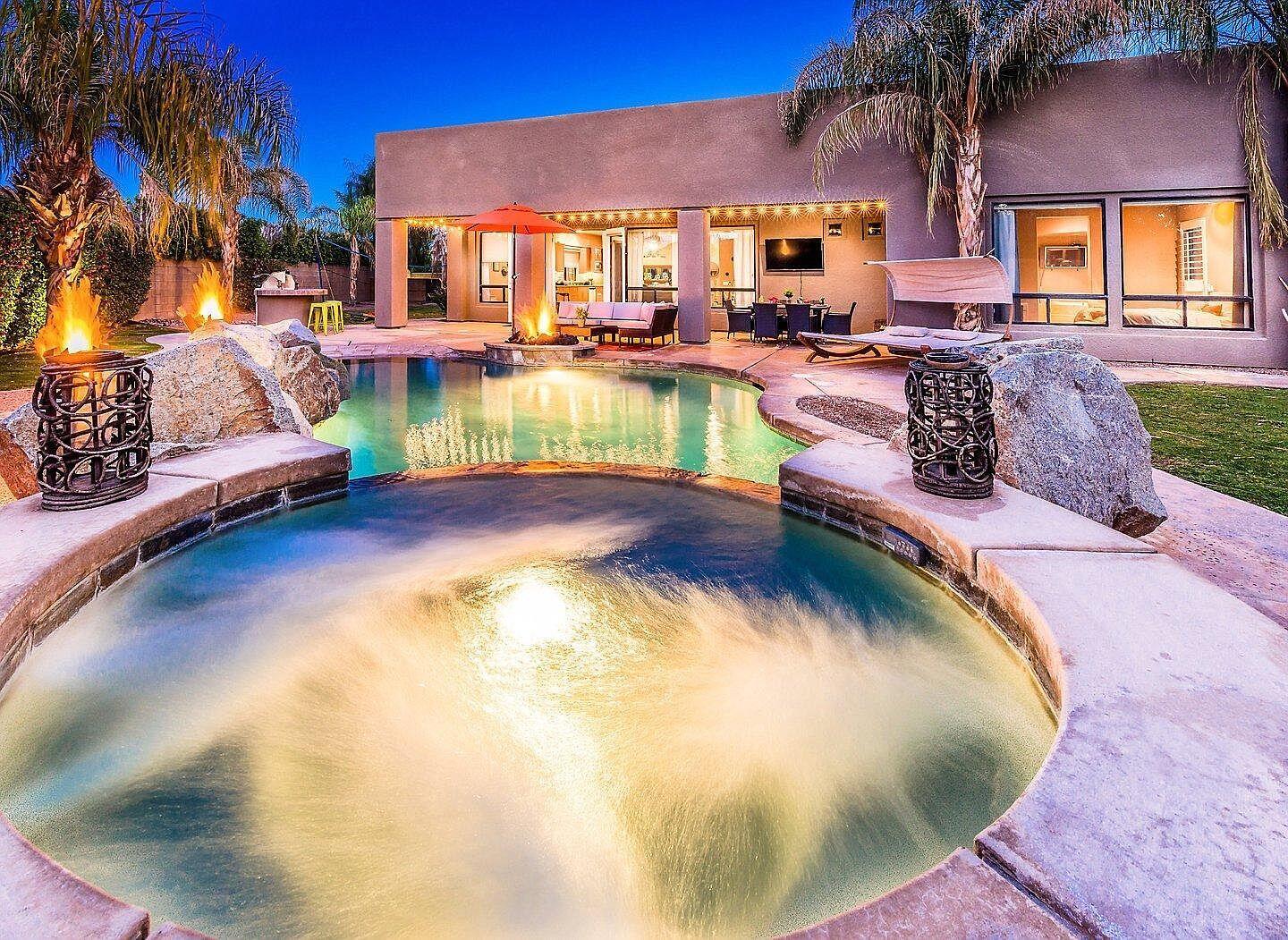 a swimming pool with outdoor seating