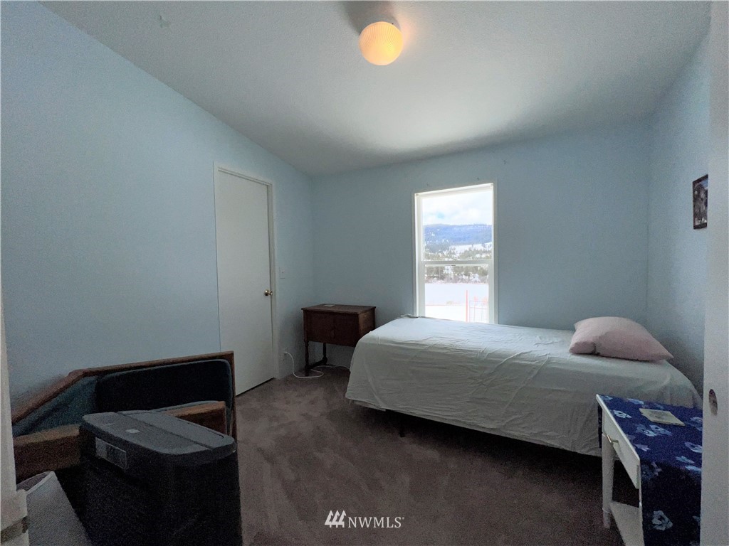 58 Heron Loop Road Republic, WA 99166 - Photo 14 of 30 a bedroom with a bed and a window