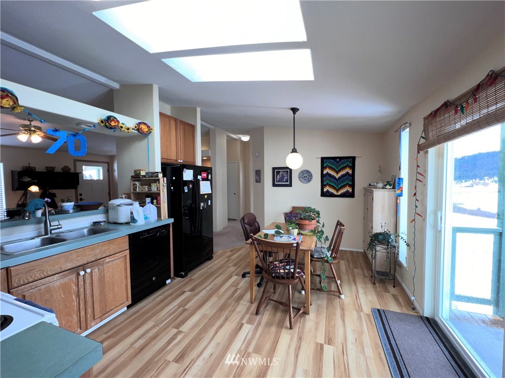 58 Heron Loop Road Republic, WA 99166 - Photo 3 of 30 a kitchen with a dining table chairs and refrigerator