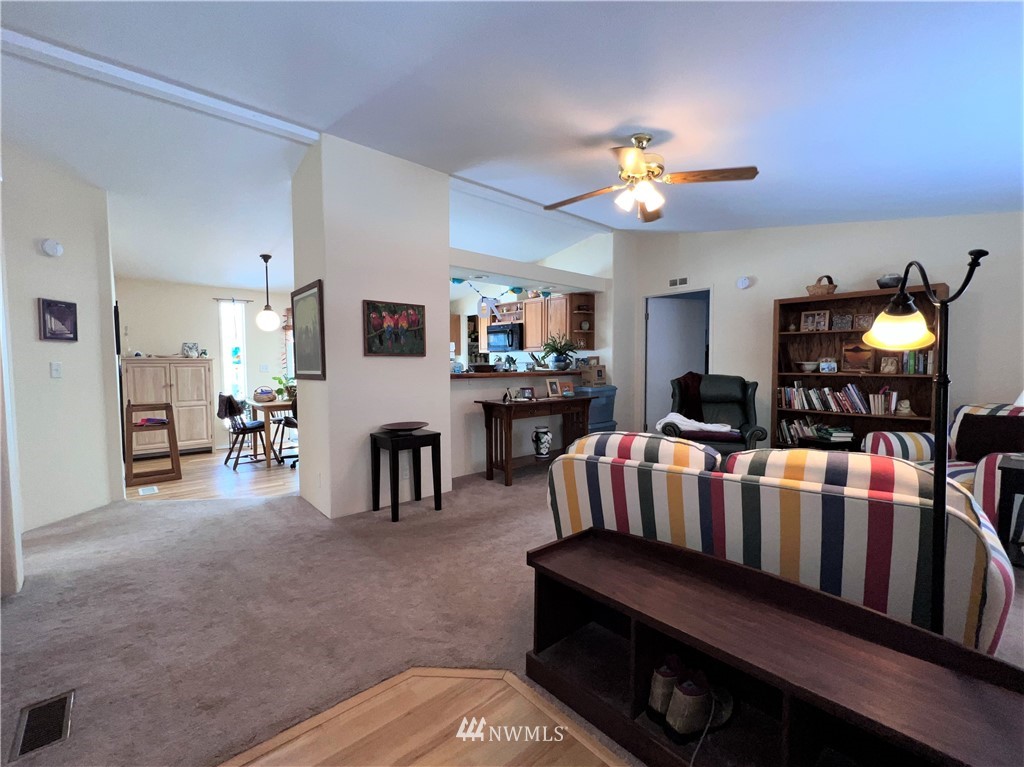 58 Heron Loop Road Republic, WA 99166 - Photo 5 of 30 a living room with furniture and a chandelier