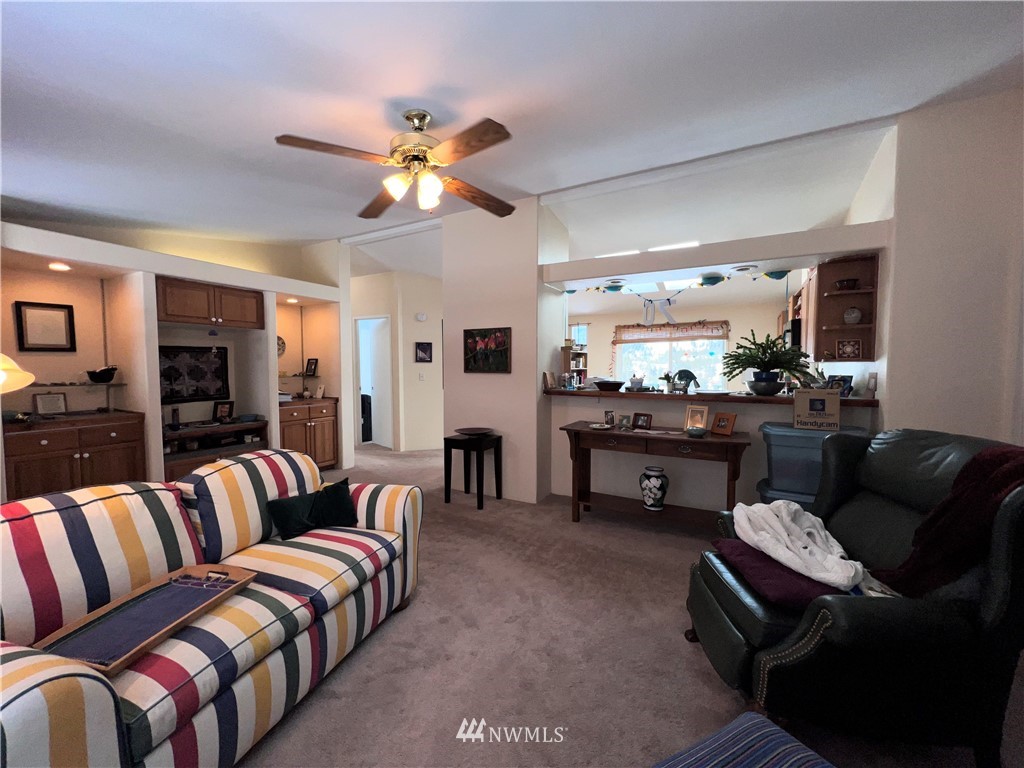 58 Heron Loop Road Republic, WA 99166 - Photo 7 of 30 a living room with furniture a ceiling fan and a flat screen tv