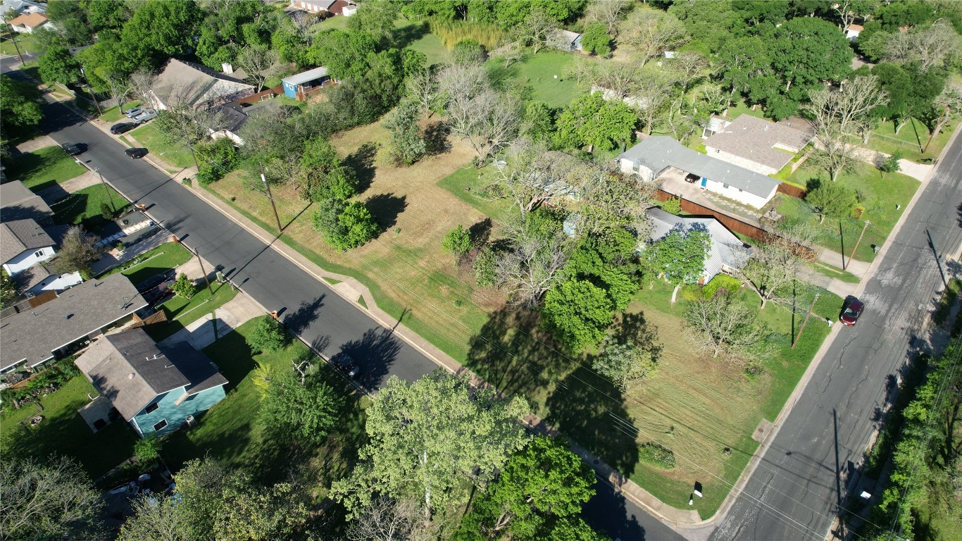 an aerial view of houses with yard