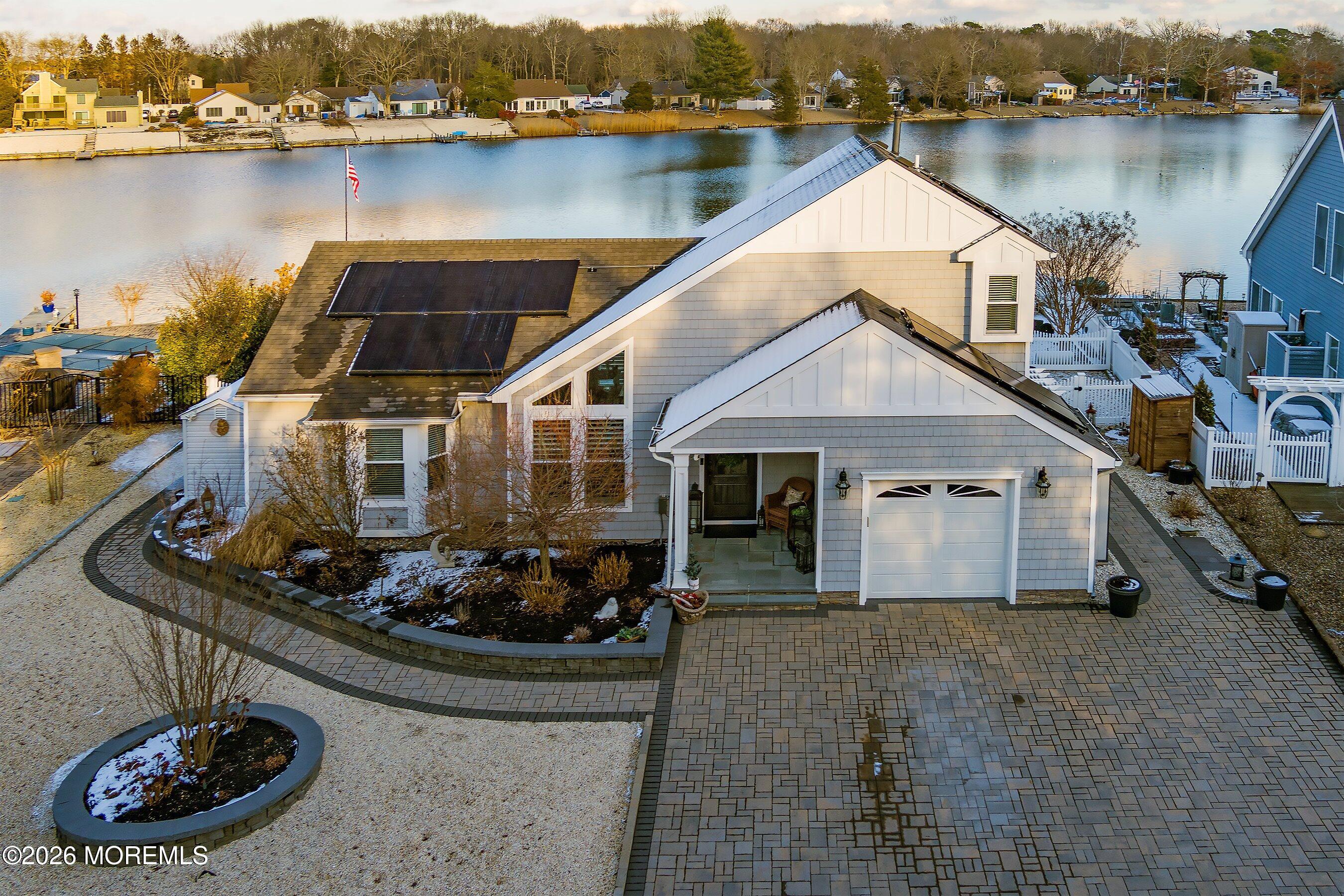 a view of a house with a yard and lake view