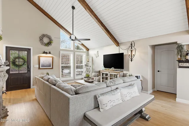 a living room with fireplace furniture and a wooden floor