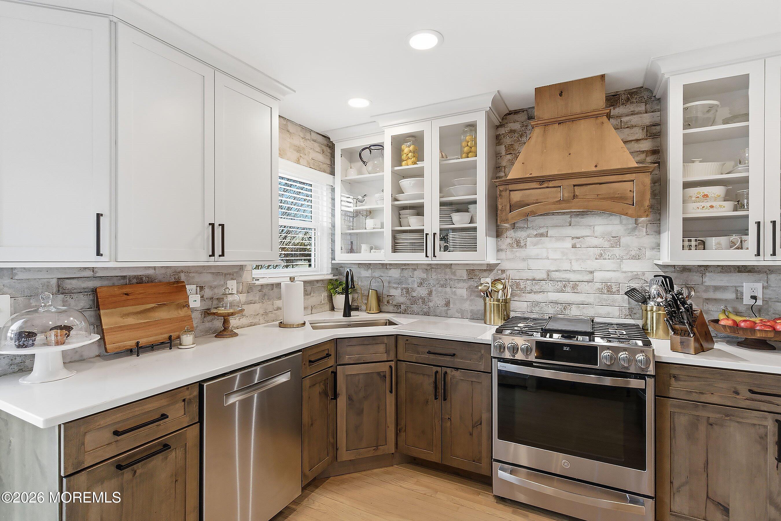 261 Timberlake Drive Manahawkin, NJ 08050 - Photo 18 of 64 a kitchen with a sink stove and cabinets