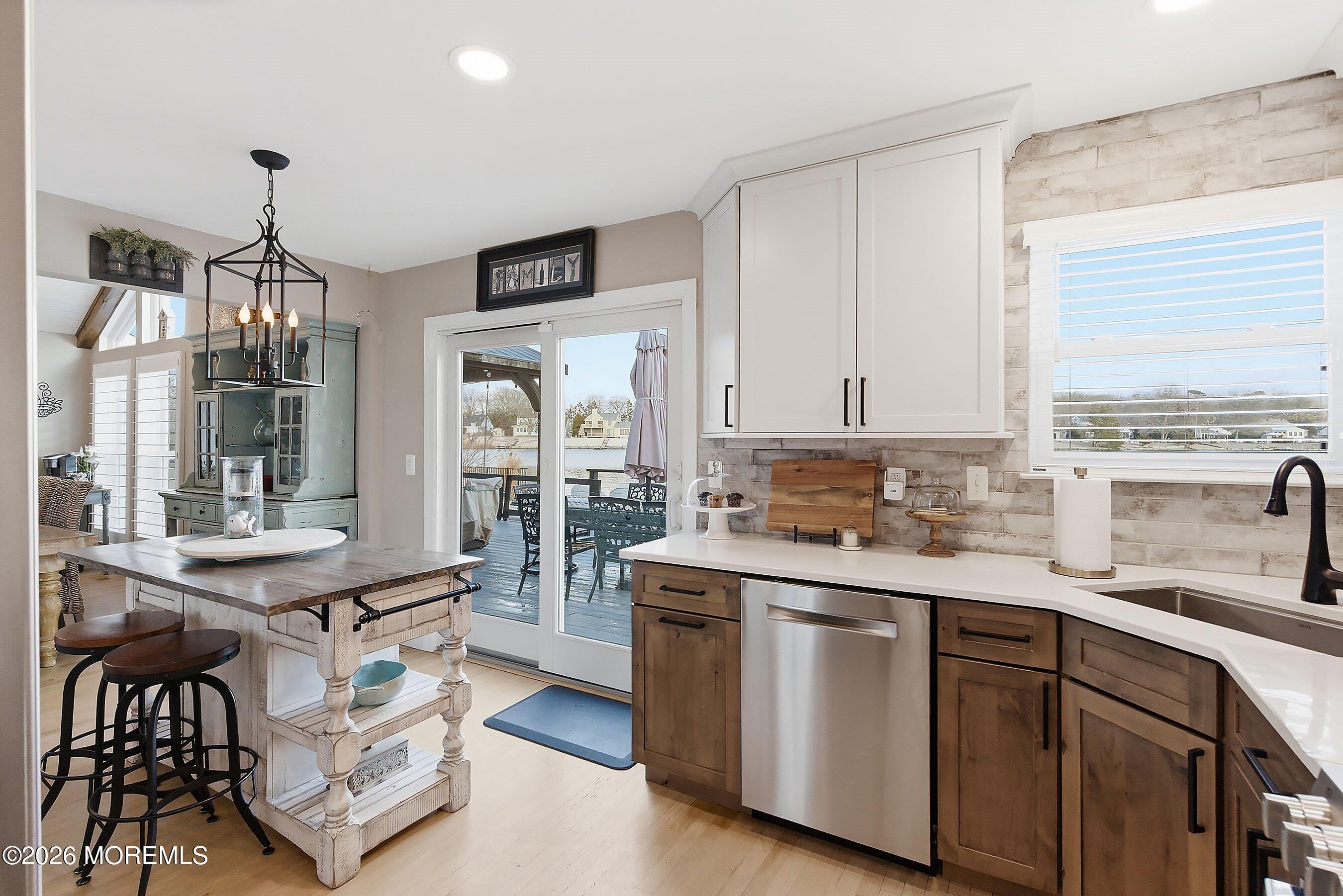 261 Timberlake Drive Manahawkin, NJ 08050 - Photo 19 of 64 a kitchen with a sink stove and cabinets