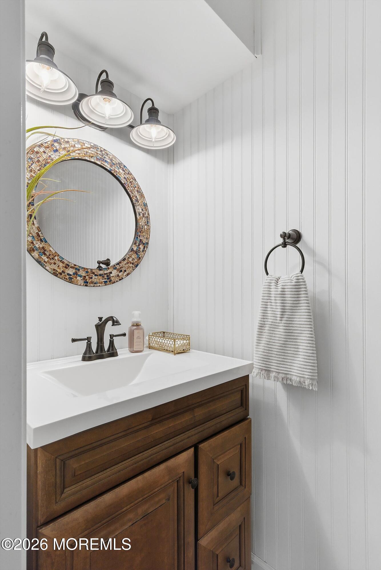 261 Timberlake Drive Manahawkin, NJ 08050 - Photo 22 of 64 a bathroom with a granite countertop sink and a mirror