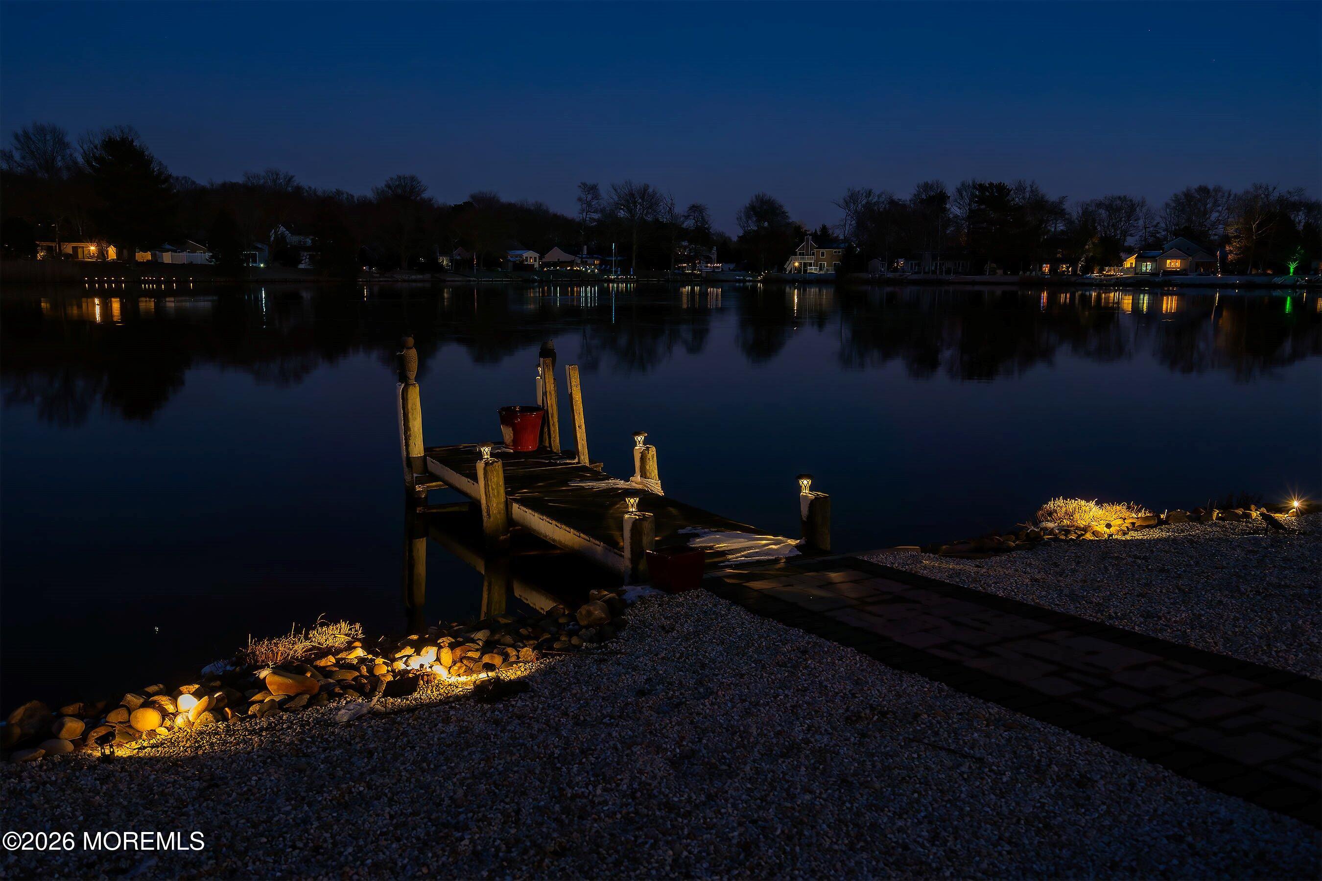 261 Timberlake Drive Manahawkin, NJ 08050 - Photo 52 of 64 a backyard of a house with table and chairs lake view