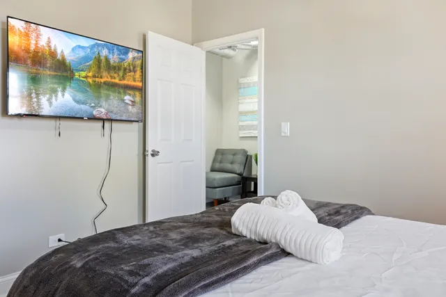a bedroom with a bed and view of bathroom