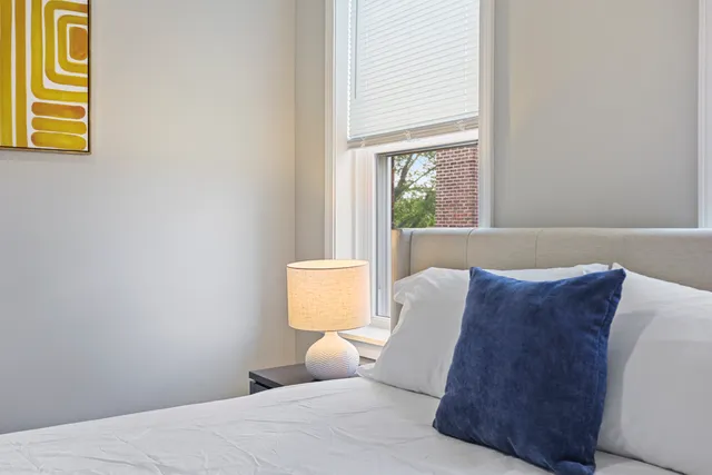 a bedroom with a bed and a window