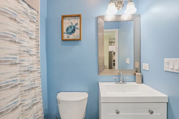 a bathroom with a toilet a sink and mirror