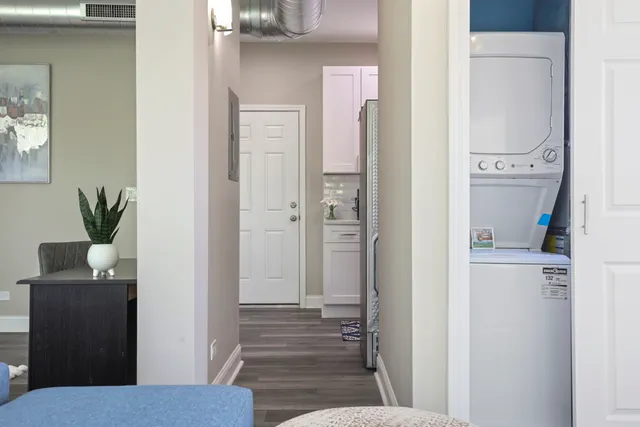 a view of a hallway with wooden floor and entryway