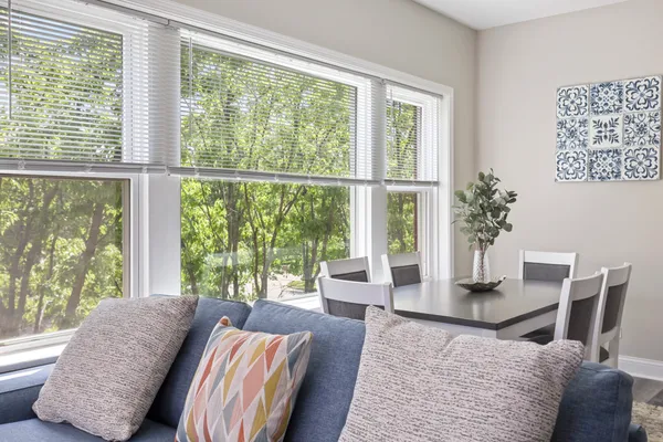 a living room with large windows and wooden floor