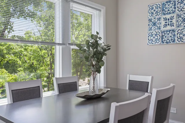 a view of a dining room with furniture and a potted plant