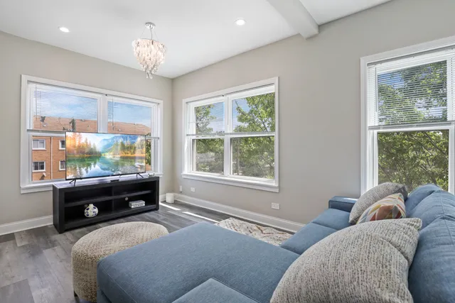 a bedroom with furniture and a large window