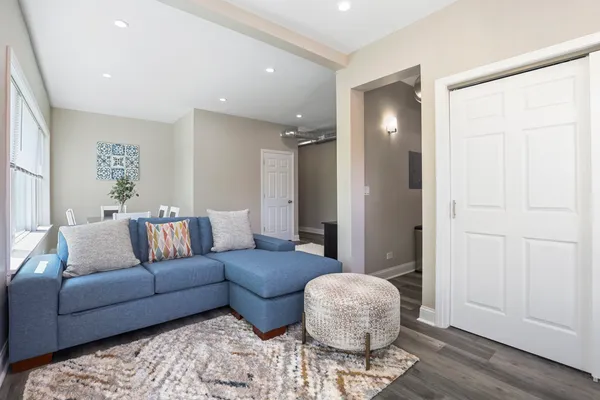 a living room with furniture and wooden floor