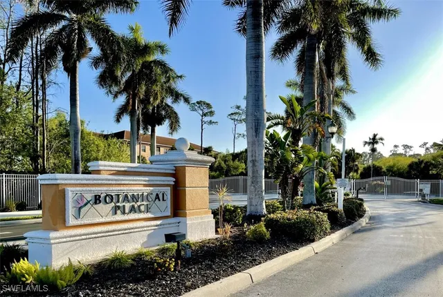 a sign board with palm trees