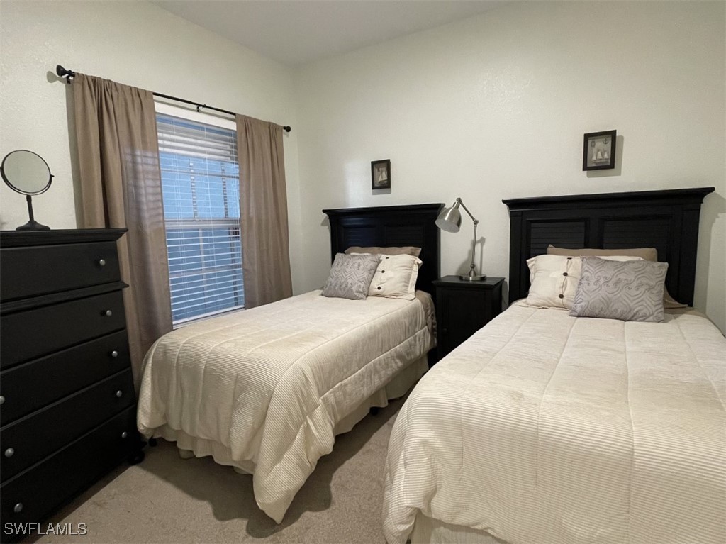 4440 Botanical Pl Circle, Unit 102 Naples, FL 34112 - Photo 12 of 21 a bedroom with two beds and painting on the wall