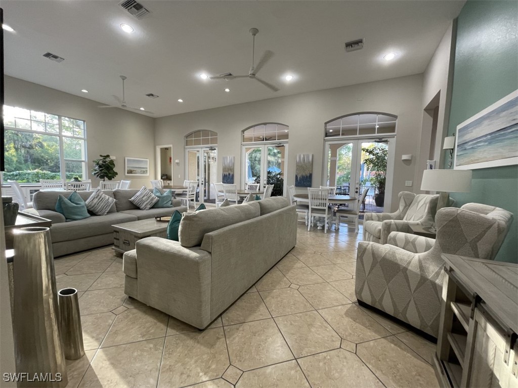 4440 Botanical Pl Circle, Unit 102 Naples, FL 34112 - Photo 18 of 21 a living room with furniture and a large window