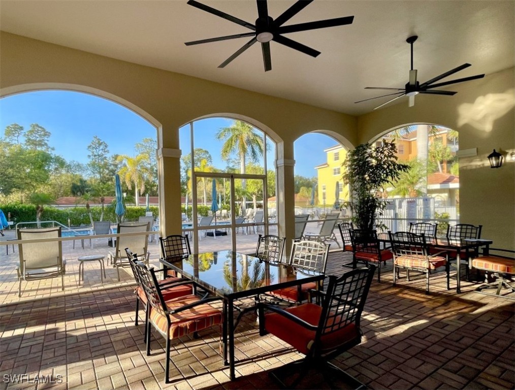 4440 Botanical Pl Circle, Unit 102 Naples, FL 34112 - Photo 20 of 21 a view of a swimming pool with outdoor seating
